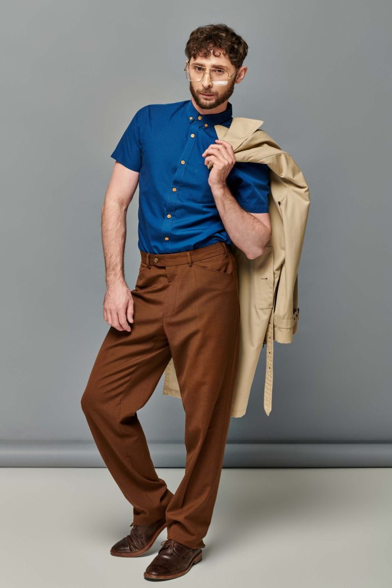 fashionable-man-posing-with-coat-on-shoulder-2026-03-11-06-50-28-utc.jpg